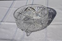 Side view of cut crystal bowl showing star and fan pattern and feet