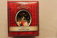 Box front showing product title and window revealing globe