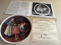 Front of "Grandma's Surprise" plate with certificate and brochure