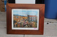 Framed folk art print with wood frame on floor