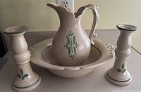 front view pitcher in bowl with candlesticks