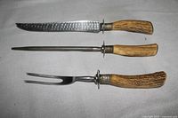 Top view of the three True Edge carving pieces showing blades, fork, steel and antler handles