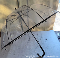 Full view of one clear umbrella opened