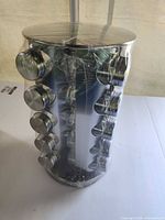 Spice rack wrapped in plastic showing jars around cylinder