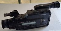 Left side view showing full body, lens, microphone, controls