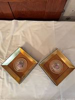 Both square gold frames with porcelain plaques displayed side by side