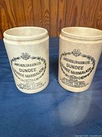 Front view of both matching James Keiller Dundee marmalade jars with printed graphics visible