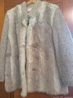 Front view showing fur body, knitted sleeves/collar, button closures