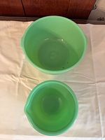 Overhead view of both green glass mixing bowls showing relative sizes
