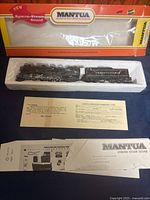 Locomotive, tender, paperwork and original box displayed