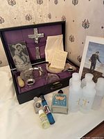 Full lot showing open sick call cabinet with contents, additional holy water bottles and vials