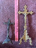 Both crucifixes beside ruler showing scale