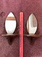 front view of both matching wooden wall shelves with mirrors and ruler for scale
