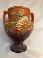 Front view showing relief freesia design, handles and overall form