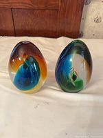 Two oval art glass paperweights, multicolour floral interiors