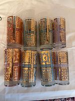 All eight tumblers upright showing full exterior designs and color variations