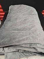 Gray weighted blanket folded on surface