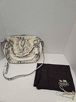 Full view of Coach snakeskin shoulder bag with dust bag