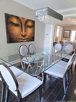 Full view of glass top dining table with stainless steel bases