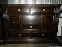 Front view showing paneled fronts and hardware