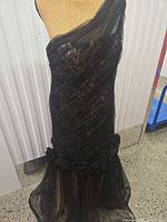 Full view of gown on mannequin showing one-shoulder neckline and overall silhouette
