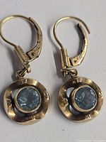 full view of both earrings showing design and stones