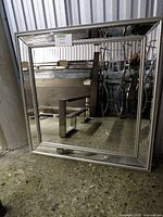 Front view showing square mirror, silver beaded frame