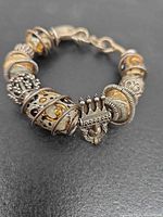 Full view of bracelet showing beads, crown charm, hook clasp