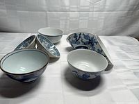Group view of bowls and oval dishes showing shapes and blue-white patterns