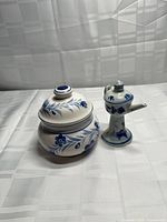 Jar and miniature pitcher side by side showing overall design and lids