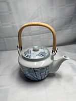 Full teapot front view showing body, lid, handle