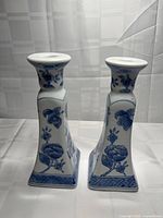 Front view of both blue and white porcelain candlestick holders