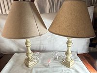 Two matching table lamps with shades, cords visible