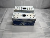 Both rectangular porcelain flower frogs top view showing perforations and central hole