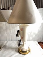 Left lamp showing ceramic body, brass base, shade, and cord