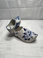 Pair of Delft-style ceramic clogs showing top and side details