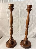 Front view of both tall wooden candlesticks