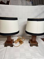 Pair of wood base table lamps with shades front view