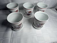Front top view showing five planters on saucers