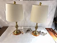 Two matching brass and wood table lamps with shades and cords