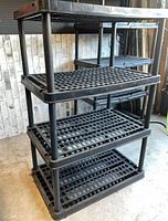 Full view of black 4-level plastic shelf