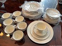 Stacked wrapped plates, bowls and cups showing quantity