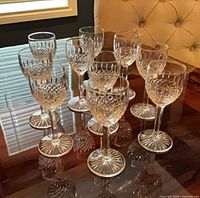 All ten Saint Louis crystal liquor glasses grouped on table, frontal view