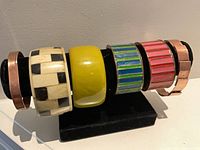 Front view of six bangles on display rod