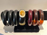 Seven bangles on display bar showing colors and styles