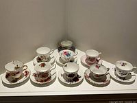 All nine teacup and saucer sets displayed together