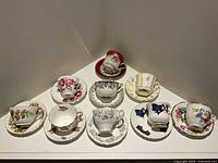 All nine teacup and saucer sets displayed together