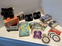 Lot overview showing three viewers, two boxes, album, and stacks of reel packets