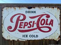 Front view showing full Pepsi-Cola Ice Cold sign with rusted edges