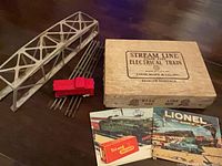 overall lot with bridge, caboose, track, box and booklets visible